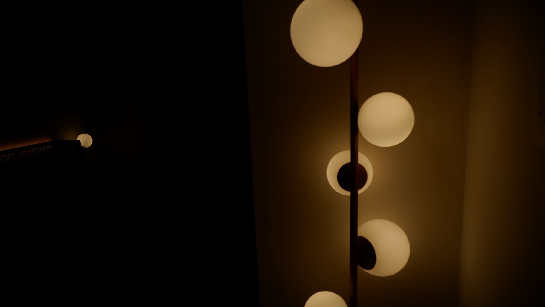 Glowing globe floor lamp in a dark room