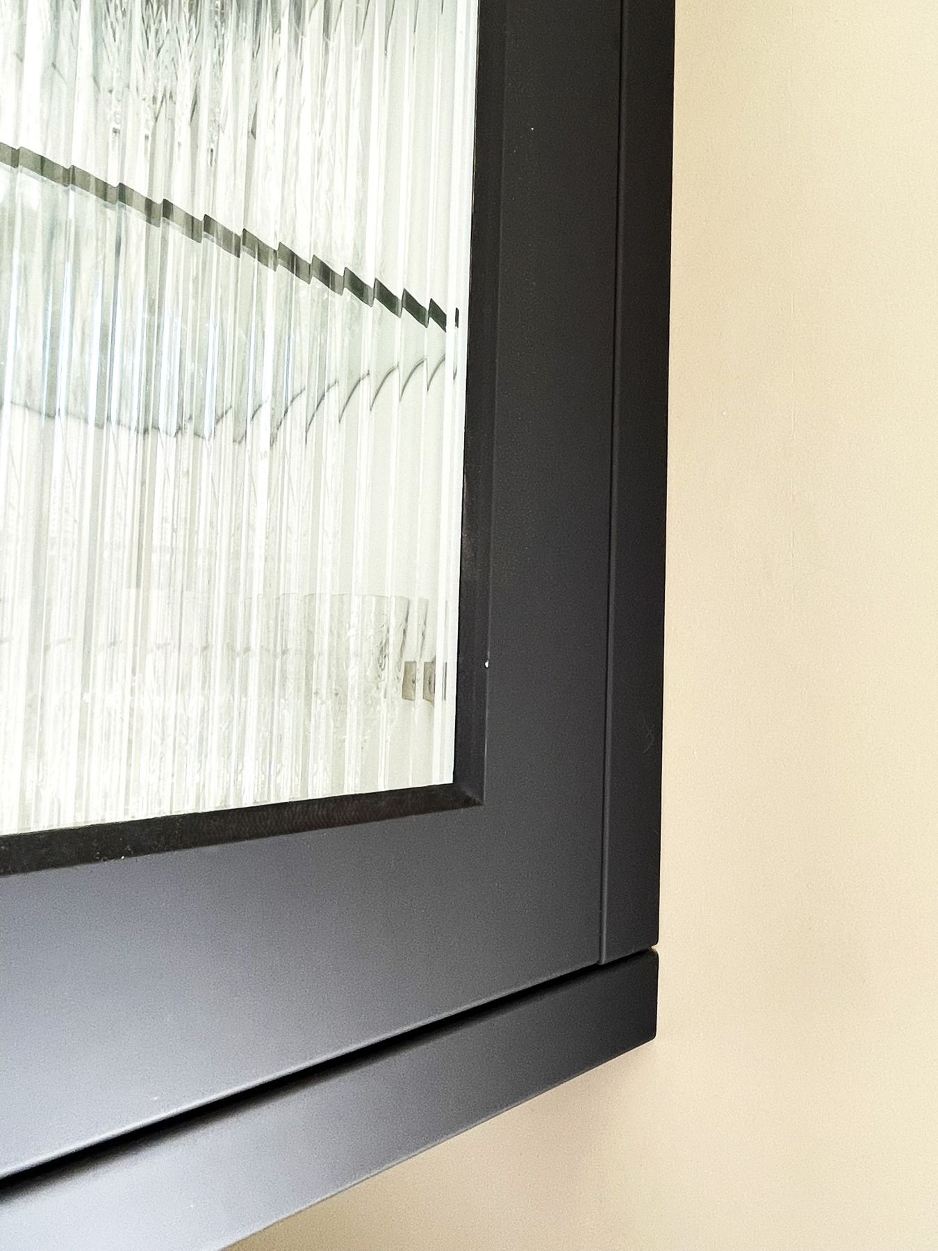 Reeded glass in a black-framed cabinet door