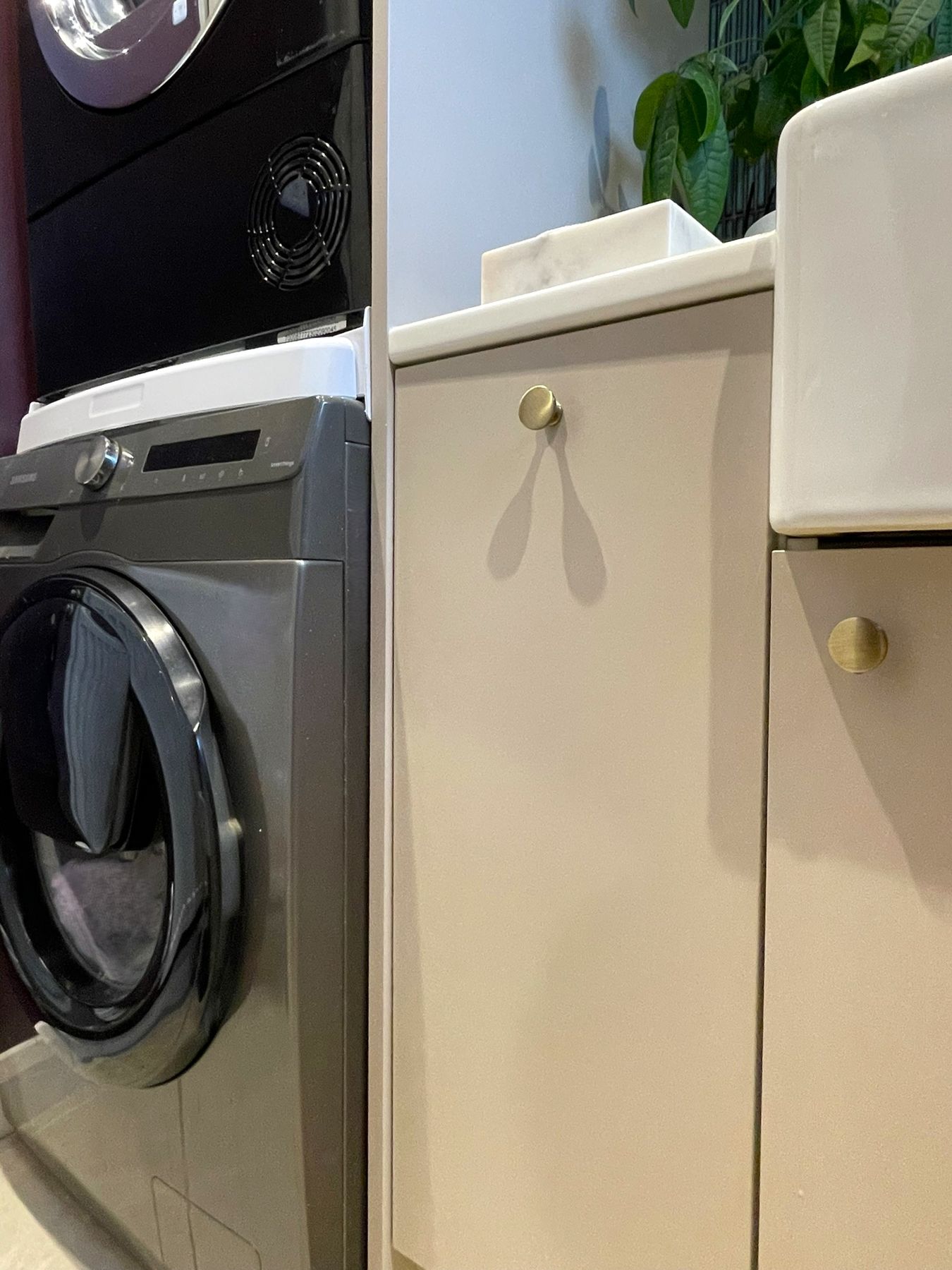 Cream cabinets beside a washing machine and dryer stack