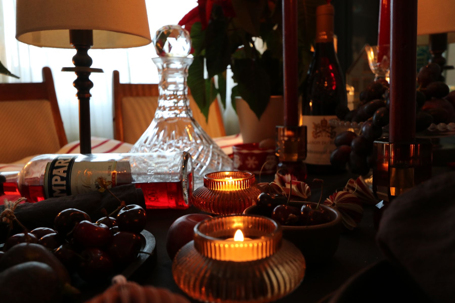 Tealights and a decanter among bowls of fruit